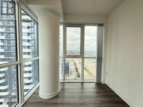 Vaughan (Vaughan Corporate Centre) condo for rent - A room with a view of the city through large windows.