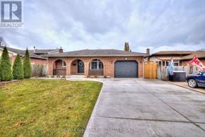 St. Catharines (Port Dalhousie) apartment for rent - A house with a garage and a car parked in front.