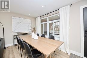 St. Catharines (Port Dalhousie) apartment for rent - A dining room with a wooden table and chairs.