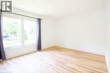 Hamilton apartment for rent - A room with a window and wooden flooring.
