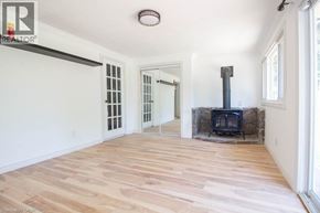 Hamilton apartment for rent - A room with a wood burning stove and a large window.