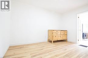 Hamilton apartment for rent - A room with a wooden floor and a wooden chest of drawers.
