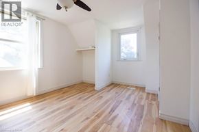 Hamilton apartment for rent - A room with wooden flooring and a ceiling fan.