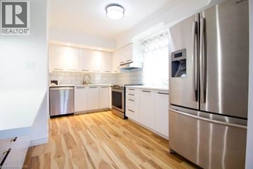 Hamilton apartment for rent - A kitchen with a refrigerator, oven, and sink.