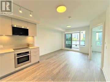 Markham (Unionville) condo for rent - A modern kitchen with a stainless steel oven and wooden flooring.