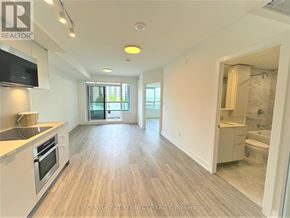 Markham (Unionville) condo for rent - A spacious kitchen and living room with wooden flooring and modern appliances.