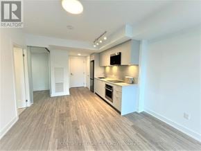 Markham (Unionville) condo for rent - A kitchen area with a sink, stove, and refrigerator.