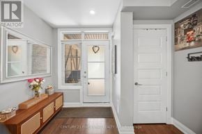 Vaughan (West Woodbridge) townhouse for rent - A hallway with a wooden bench and a door with a heart-shaped decoration on it.