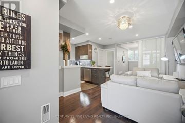 Vaughan (West Woodbridge) townhouse for rent - A modern living room with a white sofa and a chandelier.