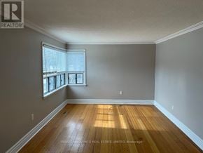Mississauga (Lakeview) apartment for rent - A room with wooden floors and a window with blinds.