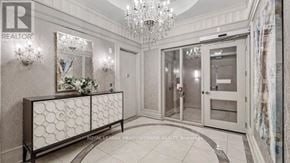 Vaughan (Concord) condo for rent - A foyer with a chandelier, a bench, and a mirror on the wall.