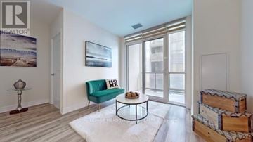 Vaughan (Concord) condo for rent - A living room with a green couch and a coffee table.
