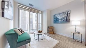 Vaughan (Concord) condo for rent - A living room with a green chair and a painting on the wall.