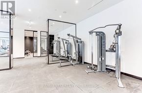 Toronto (Bay Street Corridor) condo for rent - A spacious gym with a variety of equipment including treadmills, stationary bikes, and weight machines.