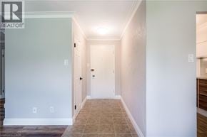 Burlington condo for rent - A hallway with a tiled floor and white walls.