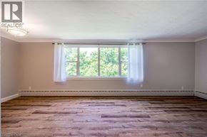 Burlington condo for rent - A room with a window and wooden flooring.