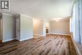 Burlington condo for rent - A room with wooden flooring and white walls.