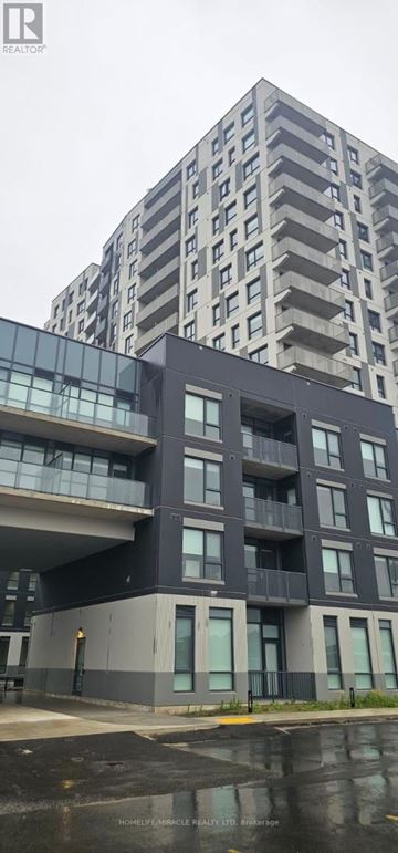 Kitchener condo for rent - A modern multi-story building with balconies and large windows.