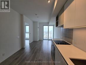 Vaughan (Vaughan Corporate Centre) condo for rent - A modern kitchen with dark wood floors and white cabinets.