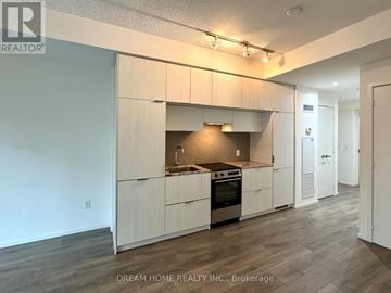 Toronto (Church-Yonge Corridor) condo for rent - A kitchen with white cabinets and a stove top oven.