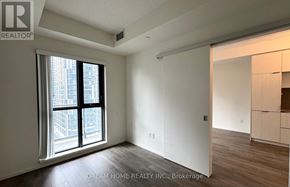 Toronto (Church-Yonge Corridor) condo for rent - A room with a large window and wooden flooring.