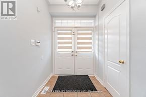 Brampton (Northwest Sandalwood Parkway) apartment for rent - A hallway with a black doormat and white walls.