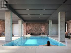 Toronto (Humber Heights) condo for rent - A woman is relaxing in a swimming pool in a spacious indoor room.