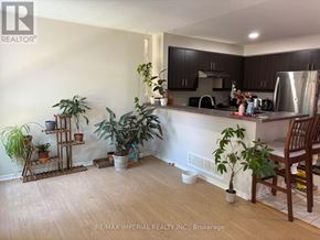 Newmarket (Stonehaven-Wyndham) apartment for rent - A kitchen with a wooden floor and a white wall.