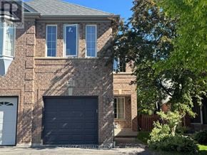 Newmarket (Stonehaven-Wyndham) apartment for rent - A house with a black garage door and a brick facade.