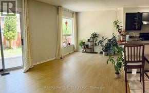 Newmarket (Stonehaven-Wyndham) apartment for rent - A living room with a sliding glass door and a dining area with a table and chairs.