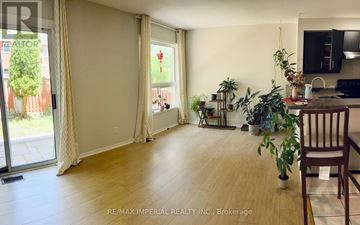 Newmarket (Stonehaven-Wyndham) apartment for rent - A living room with a sliding glass door and a dining area with a table and chairs.