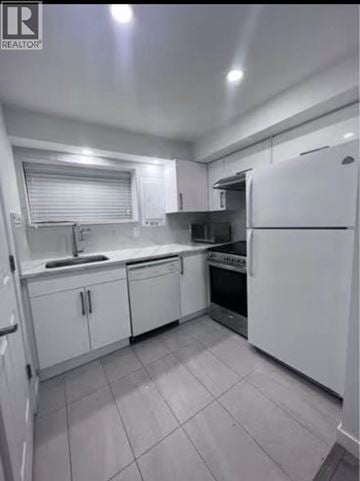 Burnaby apartment for rent - A white kitchen with tile flooring and white appliances.