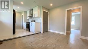 Oshawa (Eastdale) apartment for rent - A spacious kitchen with a refrigerator, microwave, and oven.