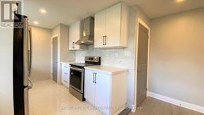 Oshawa (Eastdale) apartment for rent - A kitchen with white cabinets and appliances.