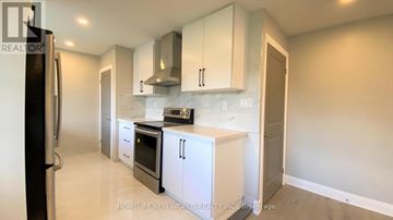 Oshawa (Eastdale) apartment for rent - A kitchen with white cabinets and appliances.