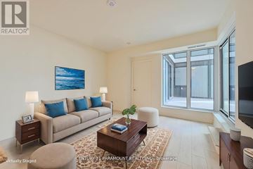 Vaughan (Vellore Village) condo for rent - A living room with a couch, a coffee table, and a painting on the wall.