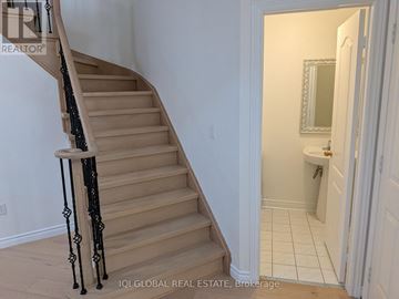 Mississauga (Churchill Meadows) apartment for rent - A kitchen with white cabinets and a stainless steel refrigerator.