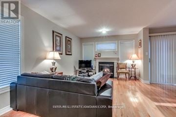 London North (North B) townhouse for rent - A living room with a black couch and a fireplace.