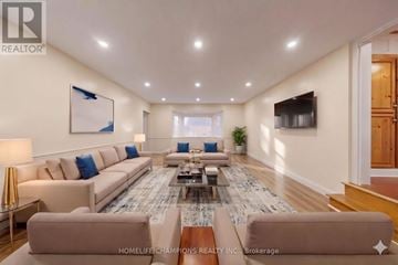 Toronto (Agincourt South-Malvern West) apartment for rent - A spacious living room with a large sectional sofa and a coffee table.