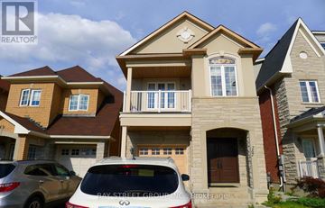 Vaughan (Patterson) apartment for rent - A white car is parked in front of a house with a sign that says "Bay Street Group".