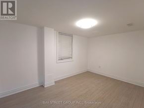 Vaughan (Patterson) apartment for rent - A room with a window and wooden flooring.