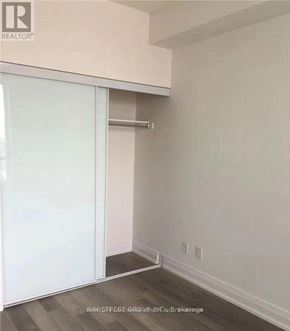 Markham (Thornhill) condo for rent - A room with a sliding door and a white wall.