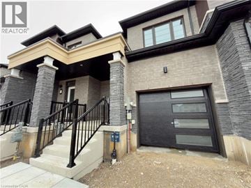 Breslau townhouse for rent - A house with a black door and a stone wall.