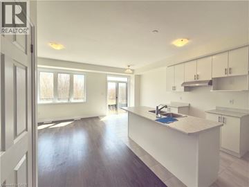 Breslau townhouse for rent - A kitchen with white cabinets and a sink.