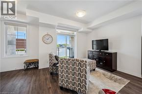 Kitchener townhouse for rent - A living room with a couch, chair, and television.