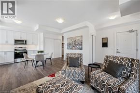 Kitchener townhouse for rent - A living room with a patterned chair and a couch.