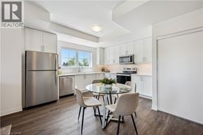Kitchener townhouse for rent - A modern kitchen with a dining table set for two.