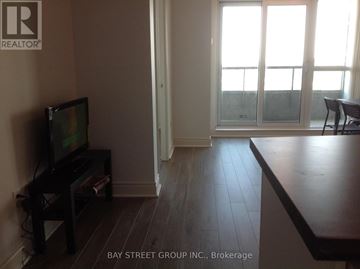Toronto (Bendale) condo for rent - A living room with a television and sliding glass doors.