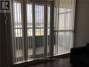 Toronto (Bendale) condo for rent - A view of the beach through a window with blinds.