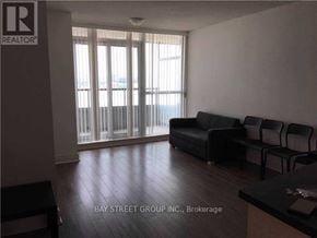 Toronto (Bendale) condo for rent - A living room with a couch, chairs, and a window with blinds.
